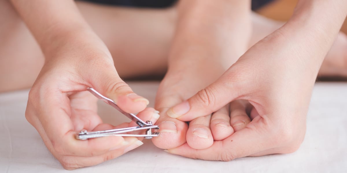 Closeup of a woman cut toenail herself, Foot care treatment and nail